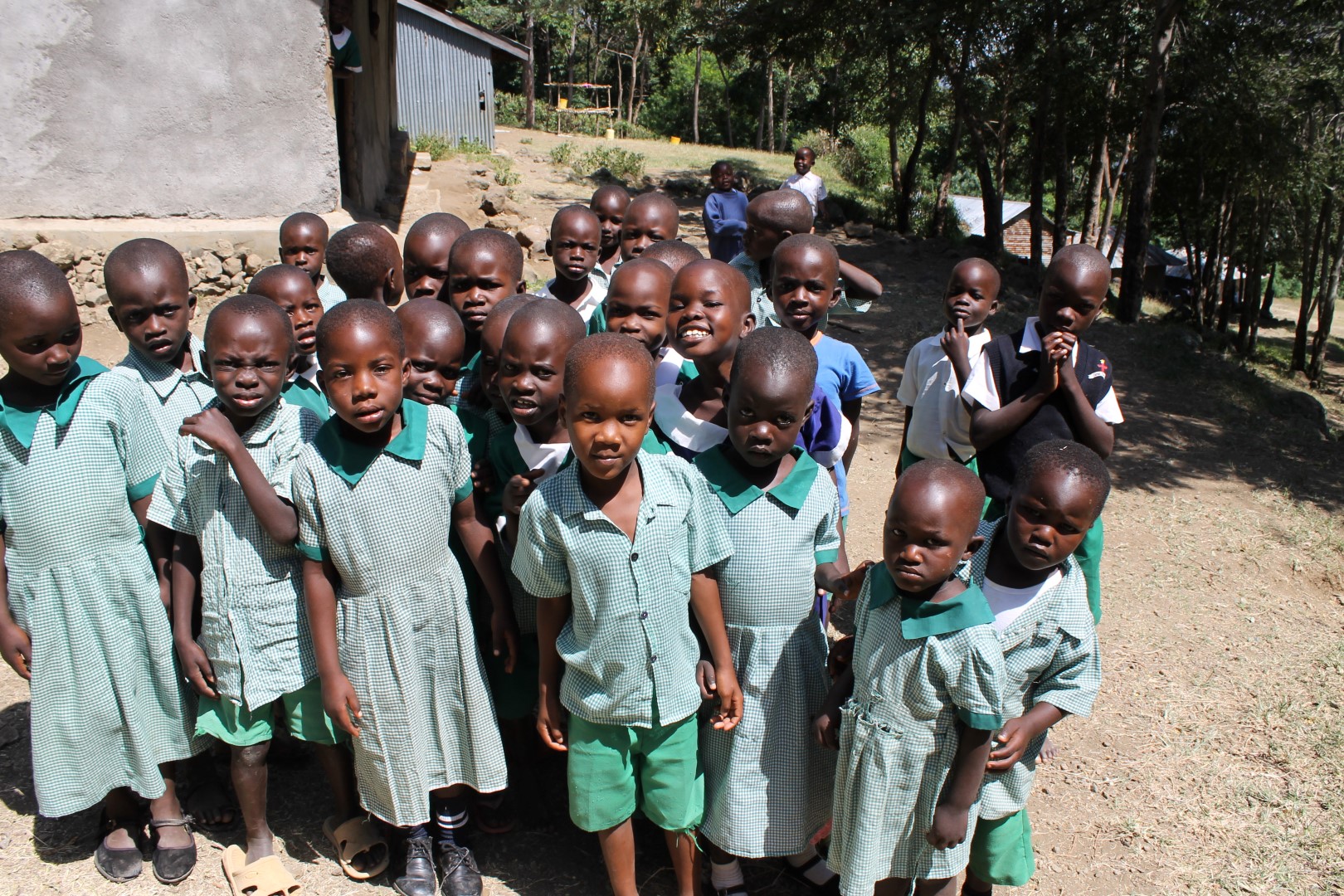 Primary school students standing together outdoors.