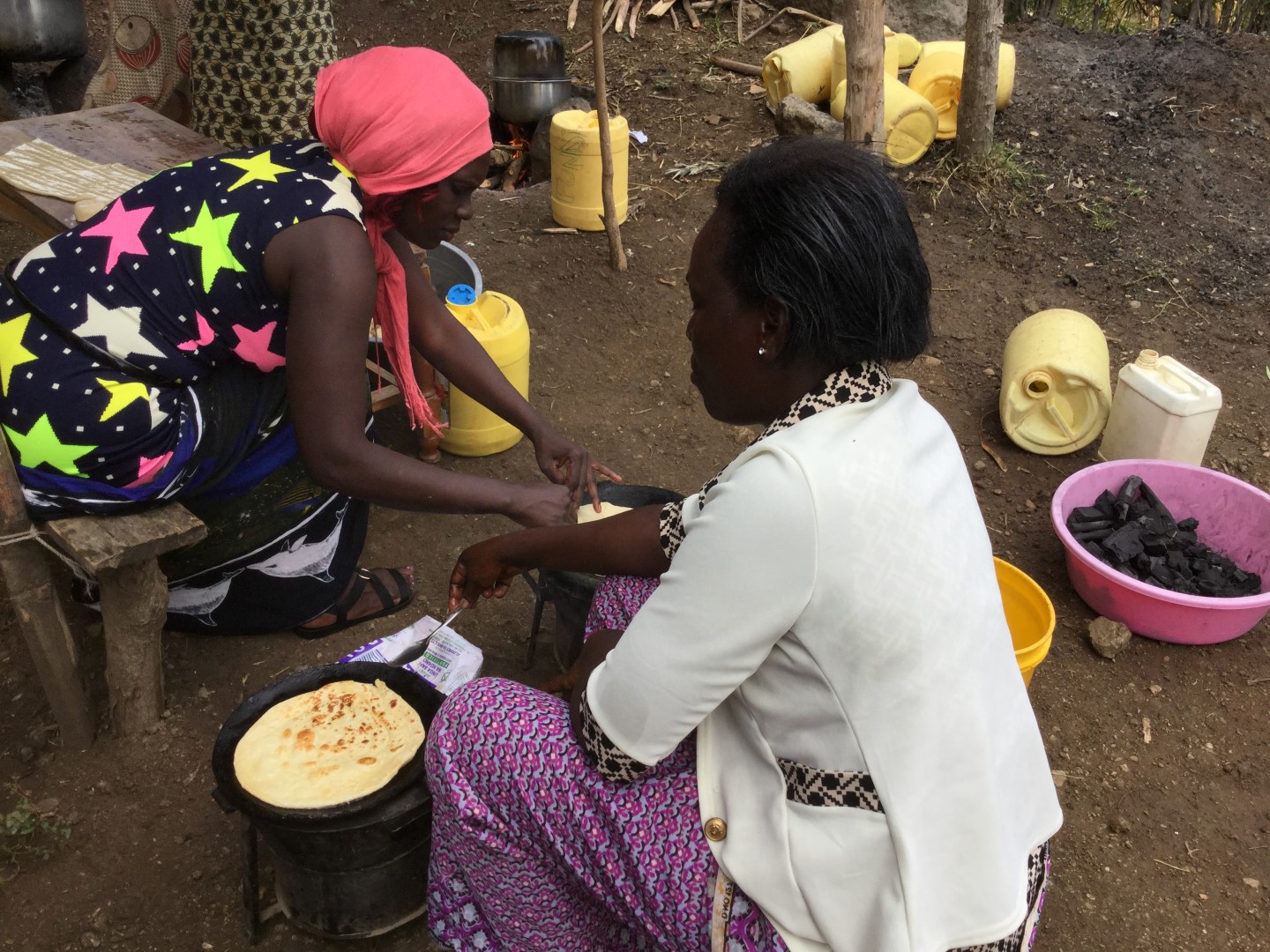 Children and a caregiver preparing a meal together.
